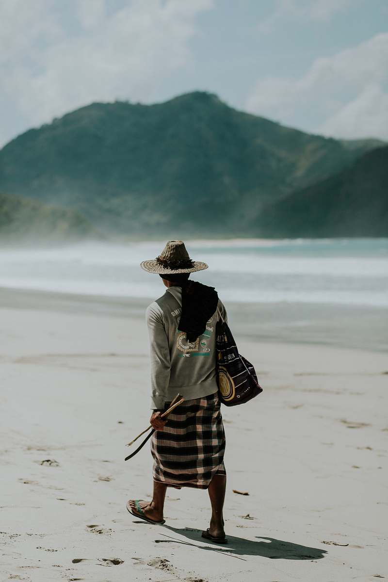 human man walking on shore under sunny sky people