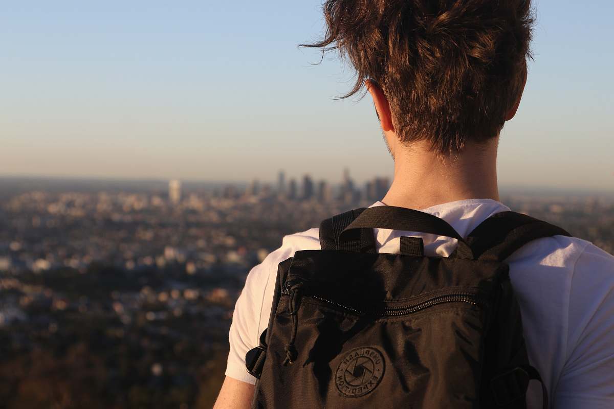 human man wearing backpack on high ground people