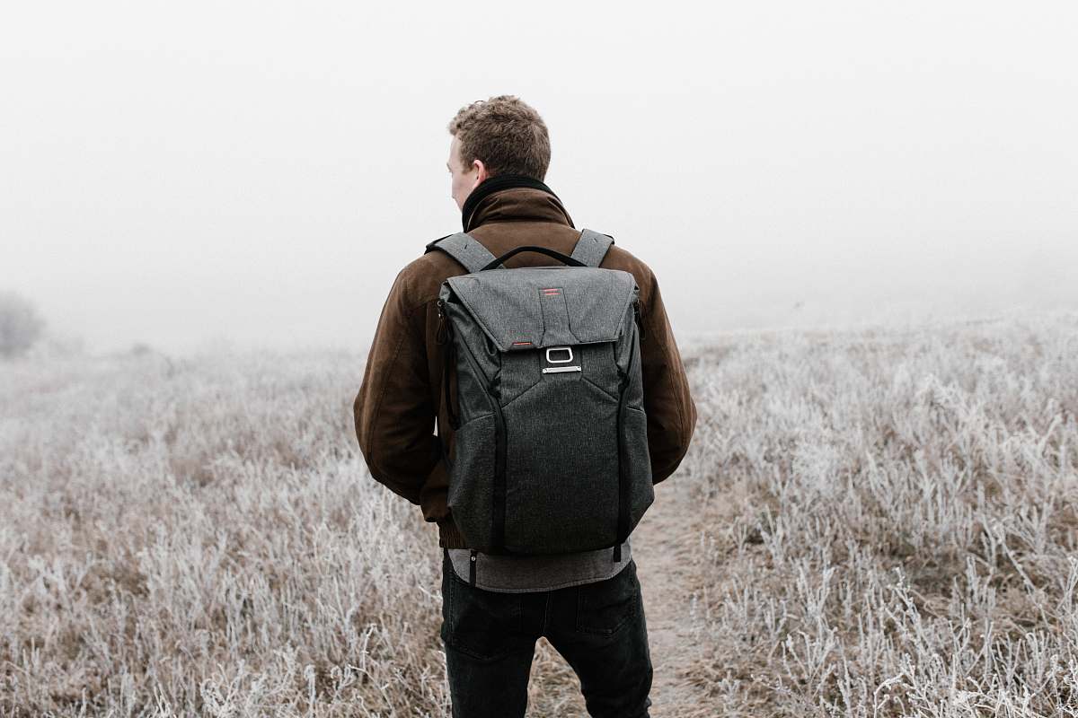 people man wearing backpack walking on pathway human