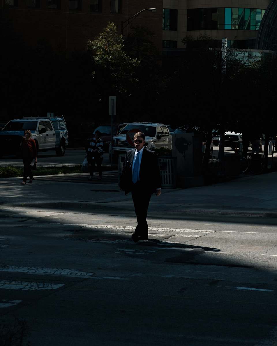 human man wearing black suit jacket and blue necktie people