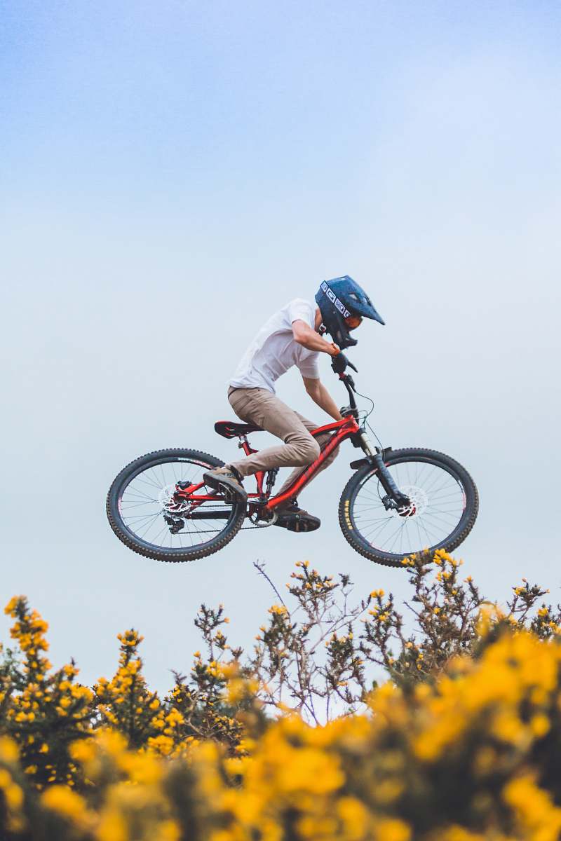 people man wearing helmet riding bicycle human