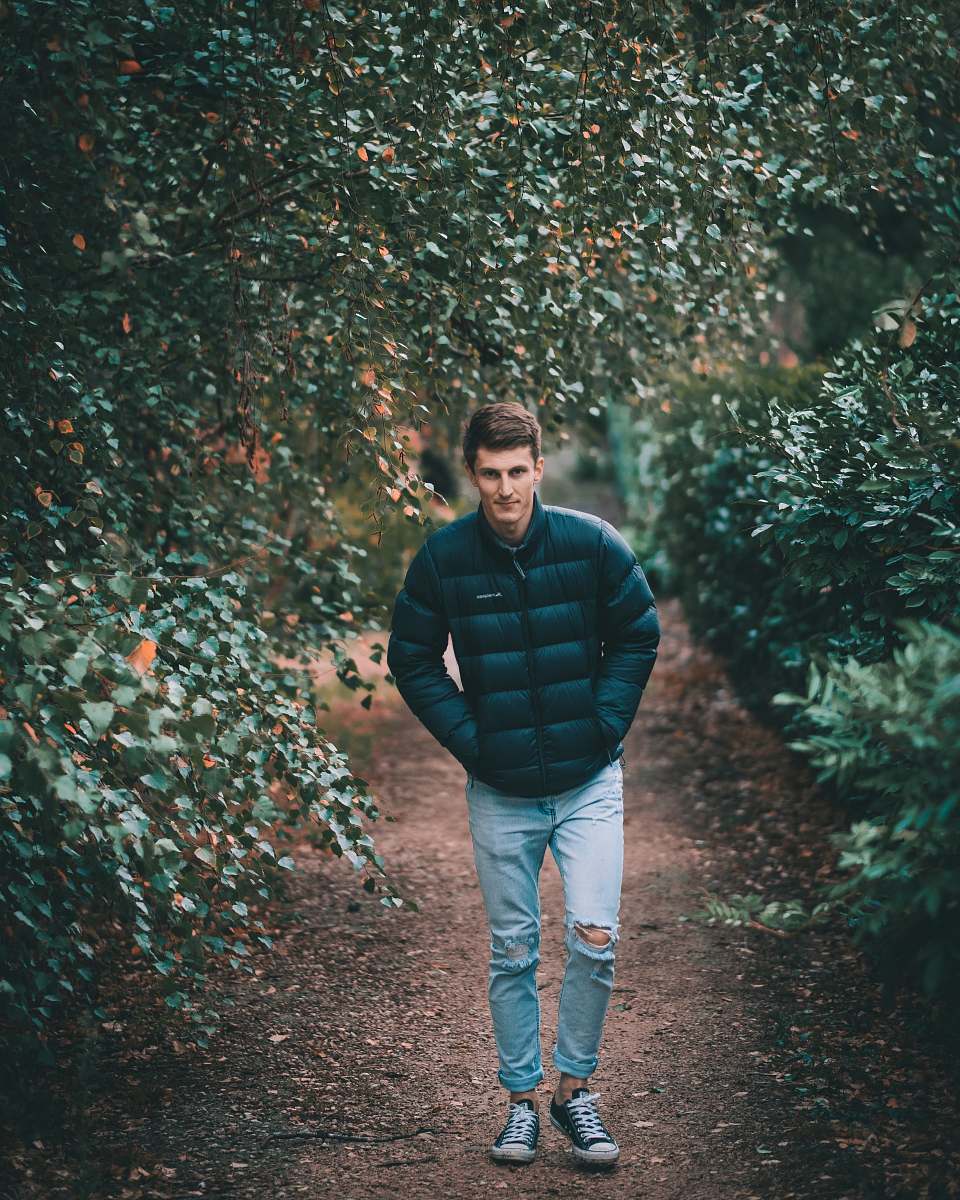 people man wearing puffer jacket between trees human