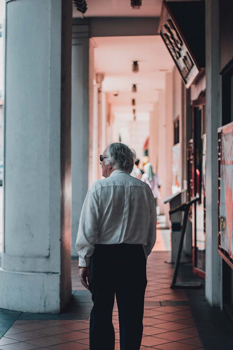 people man wearing white dress shirt walking on hallway human