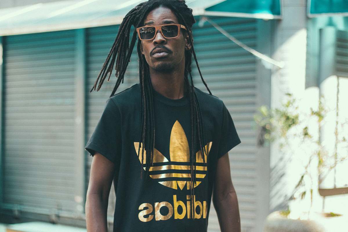 people man with dreadlocks hair wearing black and gold Adidas crew-neck shirt human