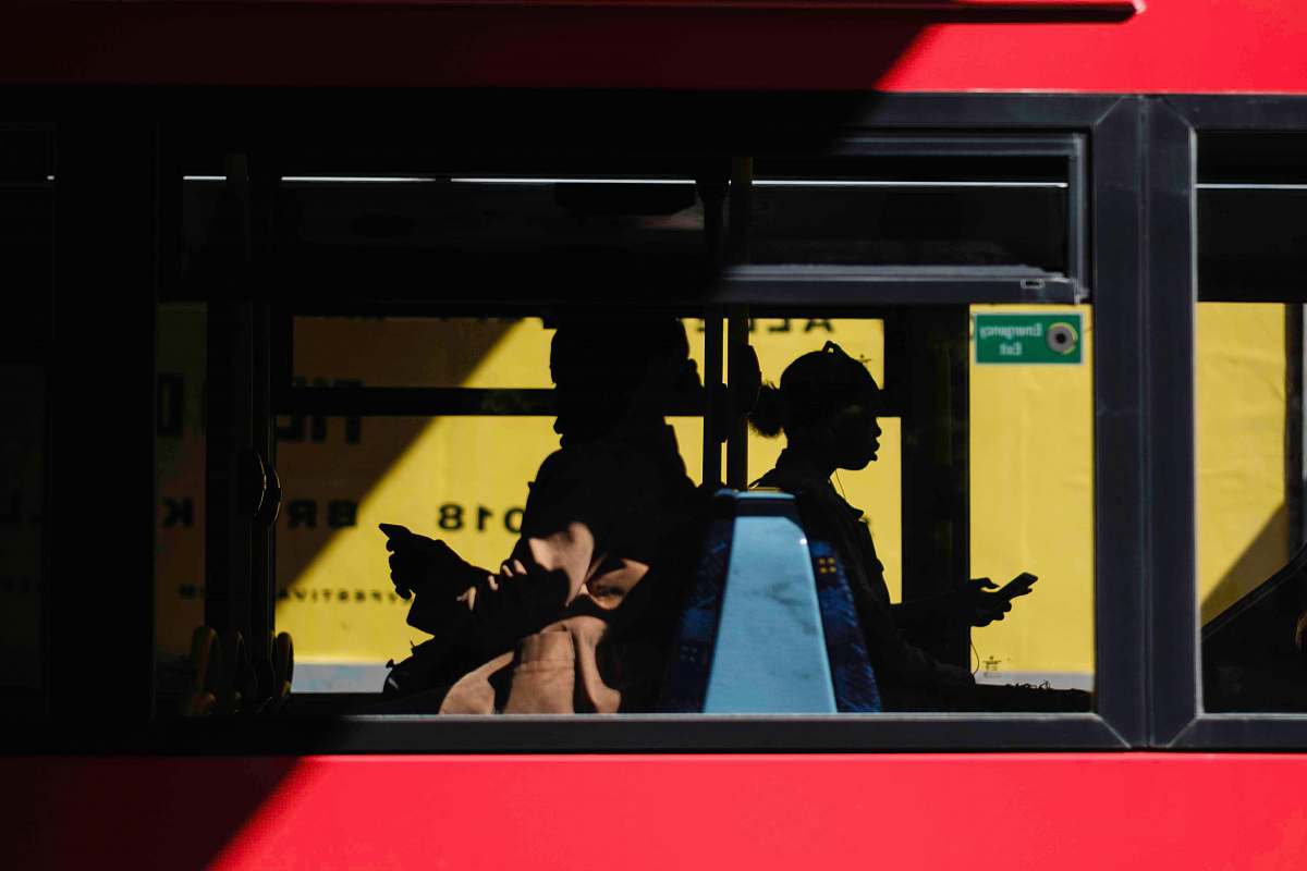 people people inside bus sitting while using smartphone human