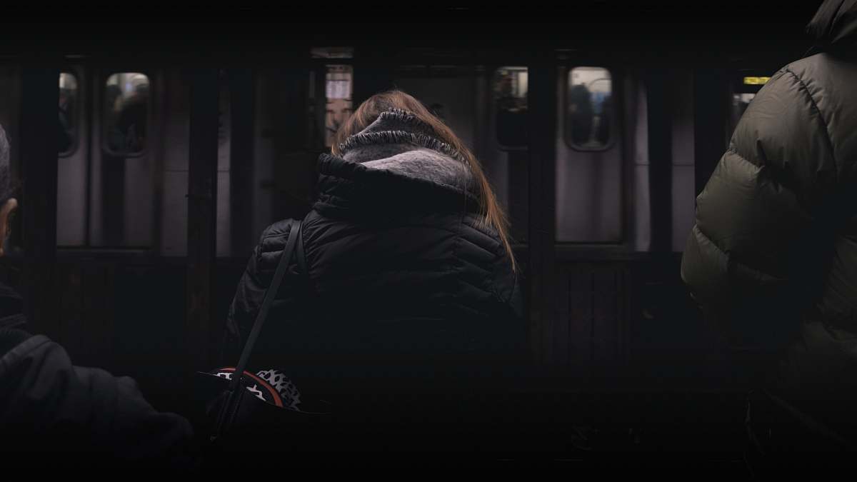 people person in black coat standing in front of white panel door human