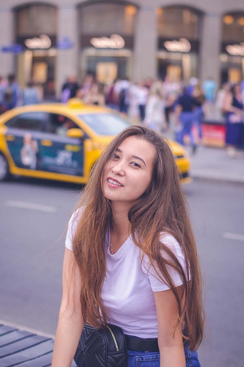 human person taking picture woman in white scoop-neck shirt people