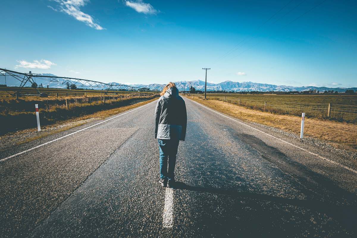 Human Person Walking On Road Under Blue Sky Road Image Free Photo