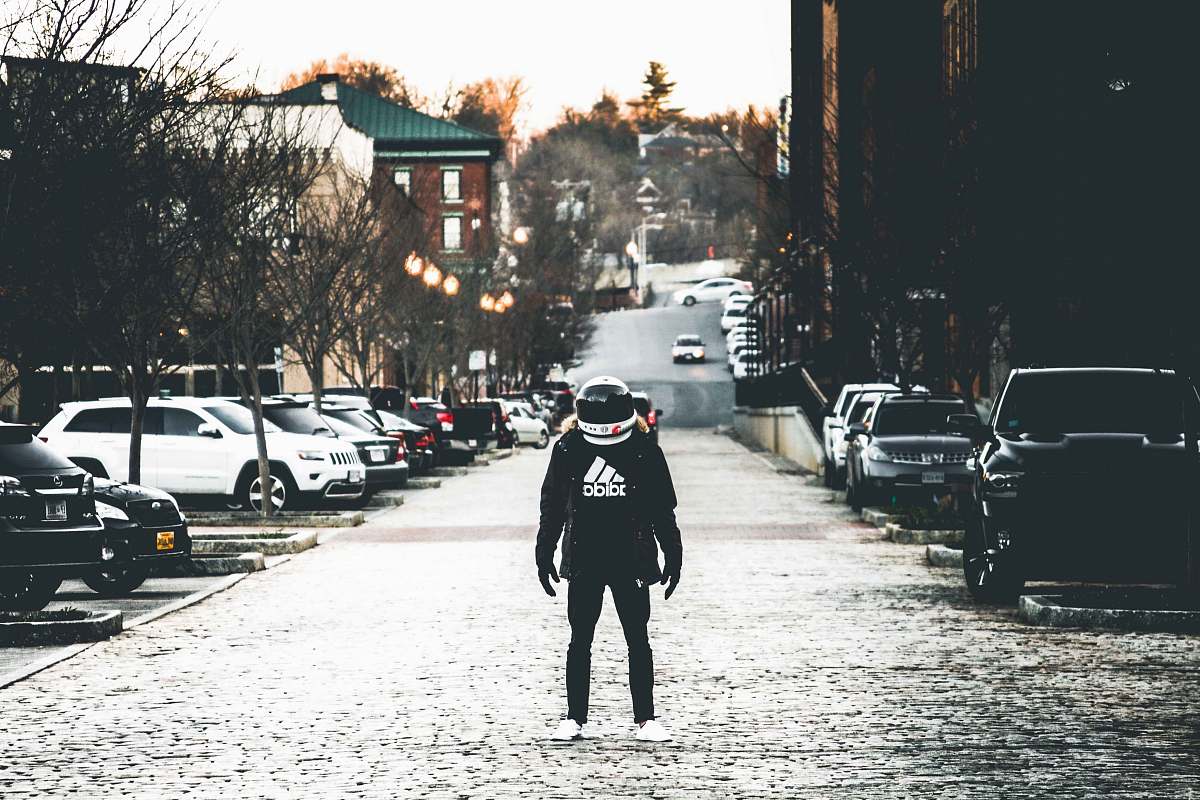 people person wearing jacket and helmet on road human