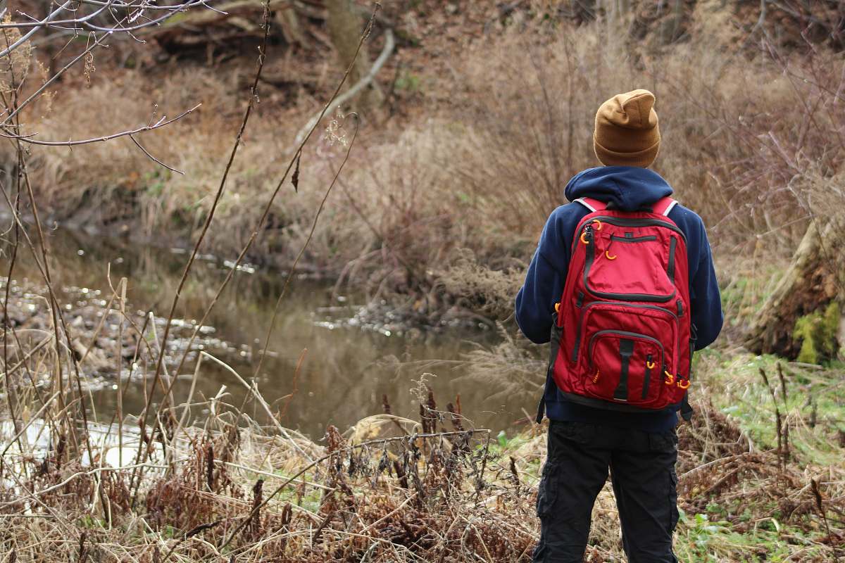 human person wearing jacket looking at river people