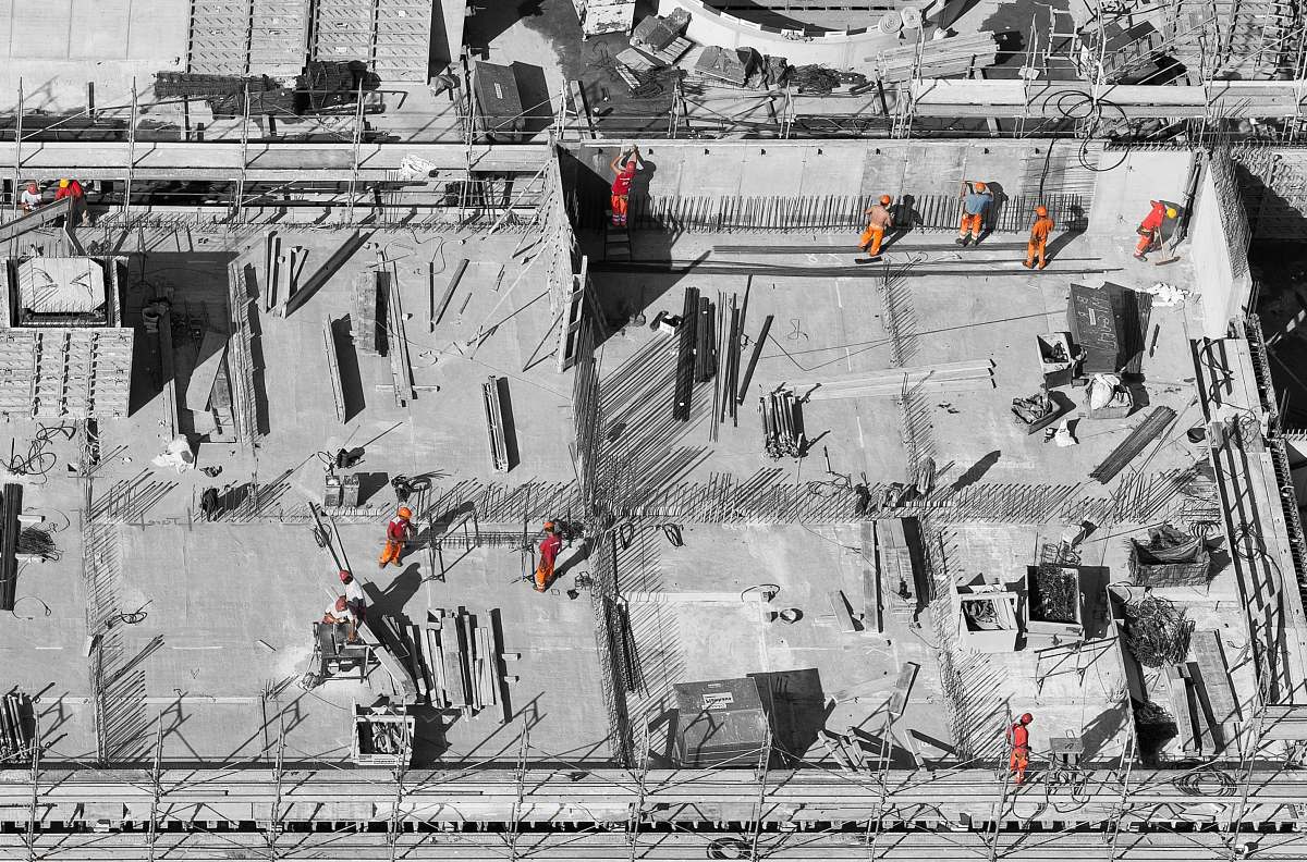 people selective color photo of man on top of gray building human