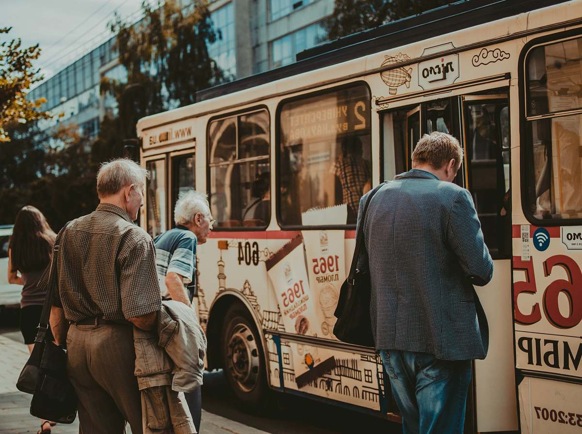 people three men standing outside bus human