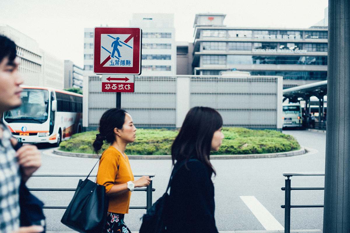 human three people walking beside metal rails people