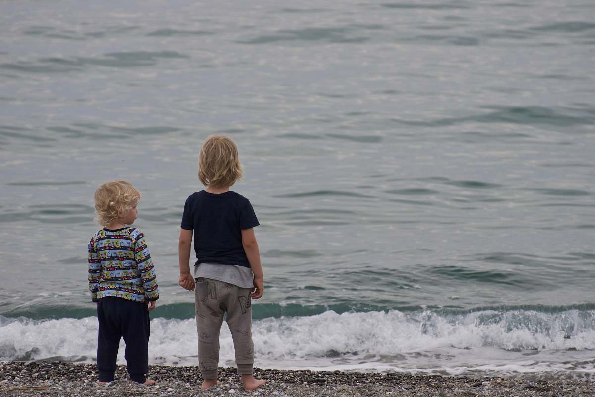 human two child standing on shore people