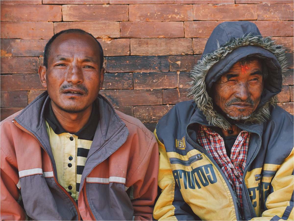 people two men leaning on wall human