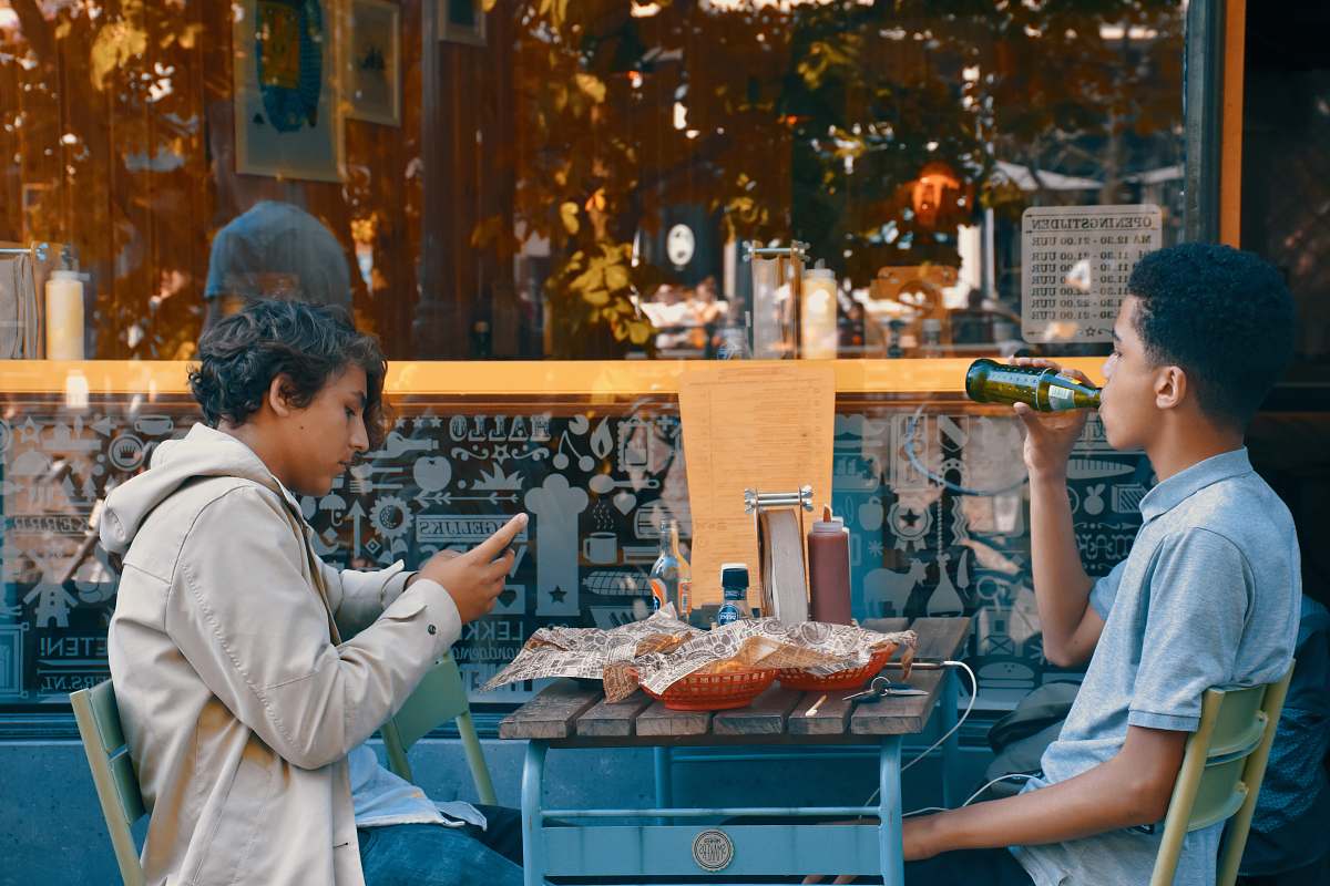 people two men sitting on chair front of table human