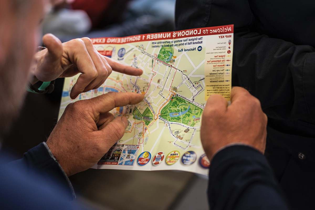 people two people pointing at London's number one sightseeing map human