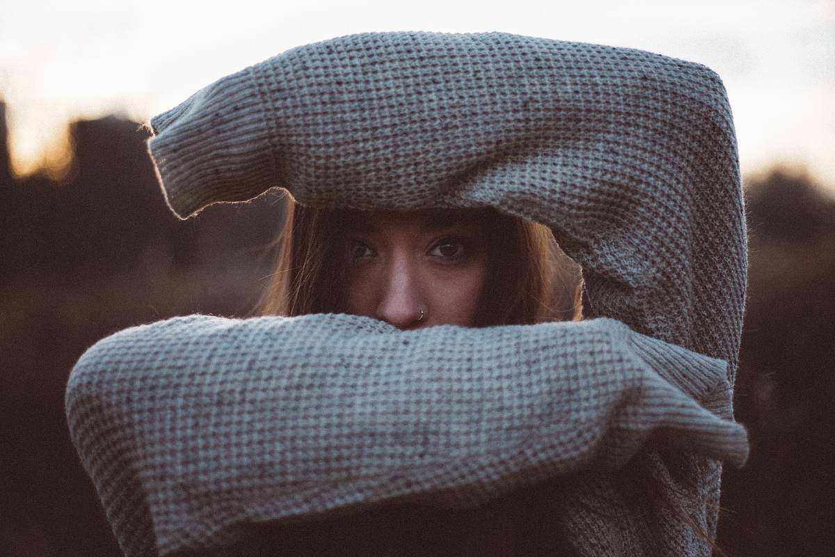 people woman hiding her face sweater