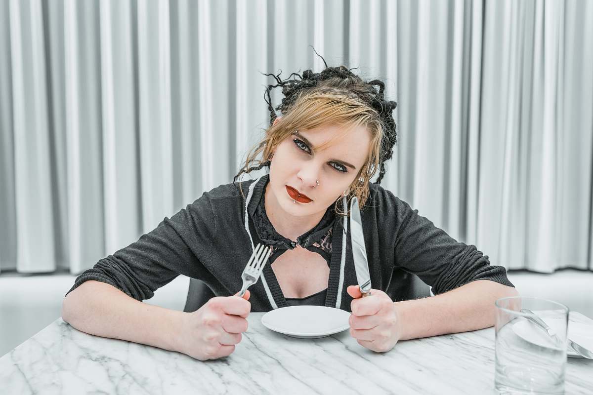 human woman holding fork and knife inside room people