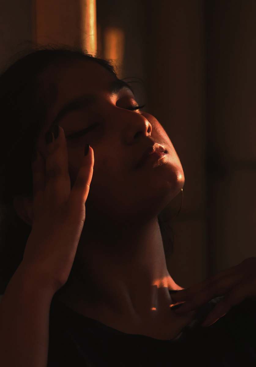 people woman holding her head on dark human
