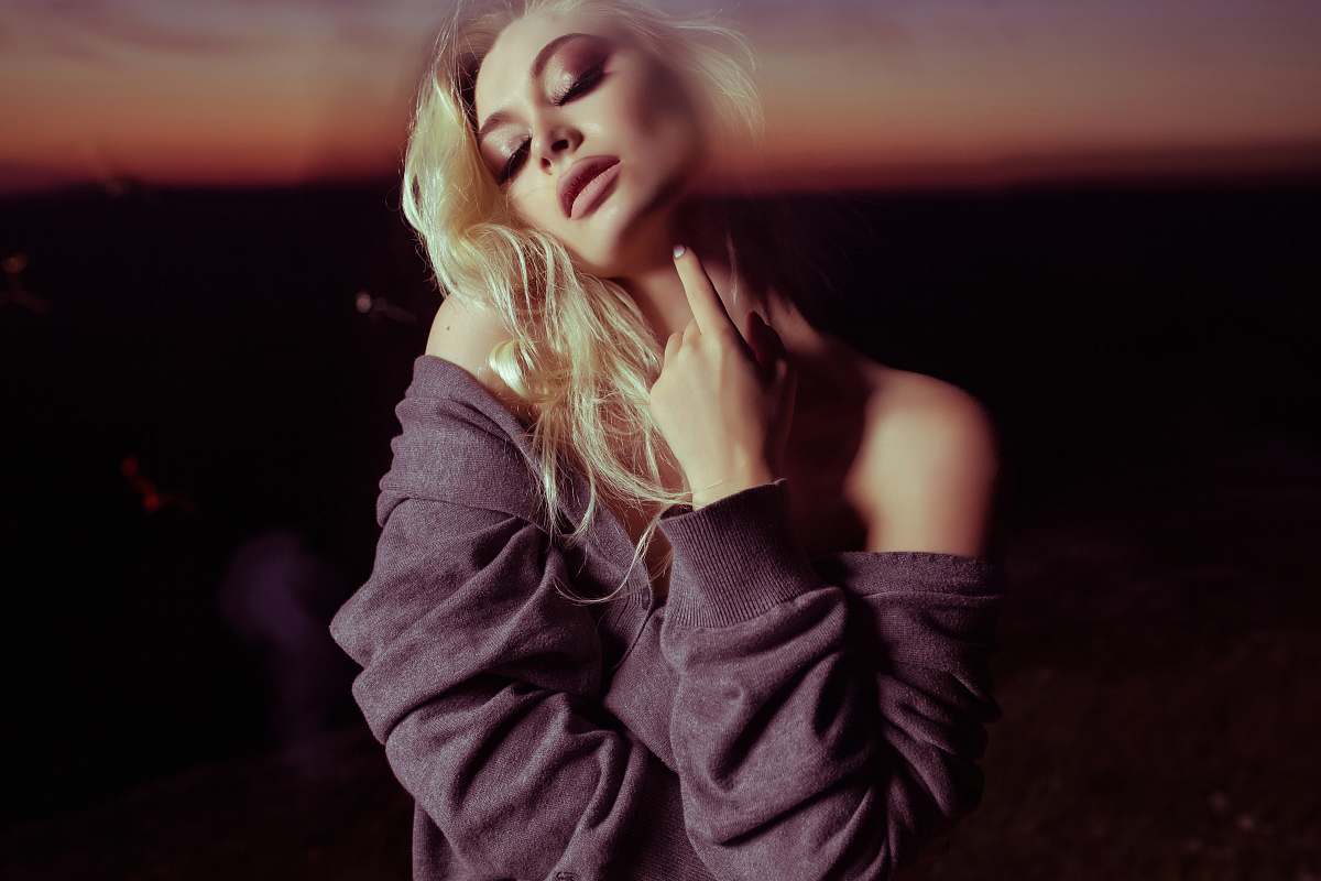 people woman holding her neck inside dark room human