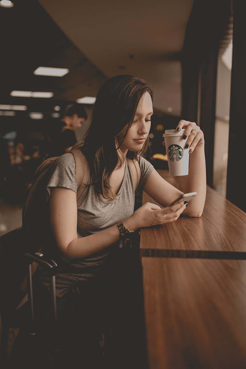 people woman holding starbucks disposable cup and smartphone human