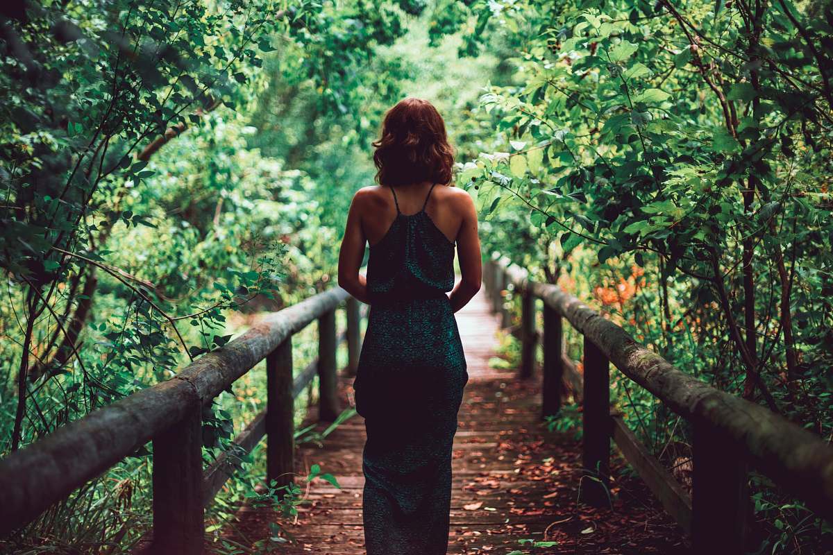 people woman in black dress standing on bridge human