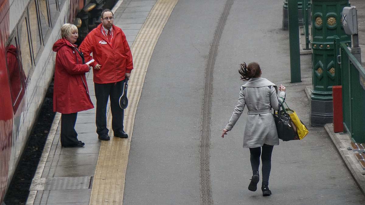 people woman in gray coat walking on the road during day time human