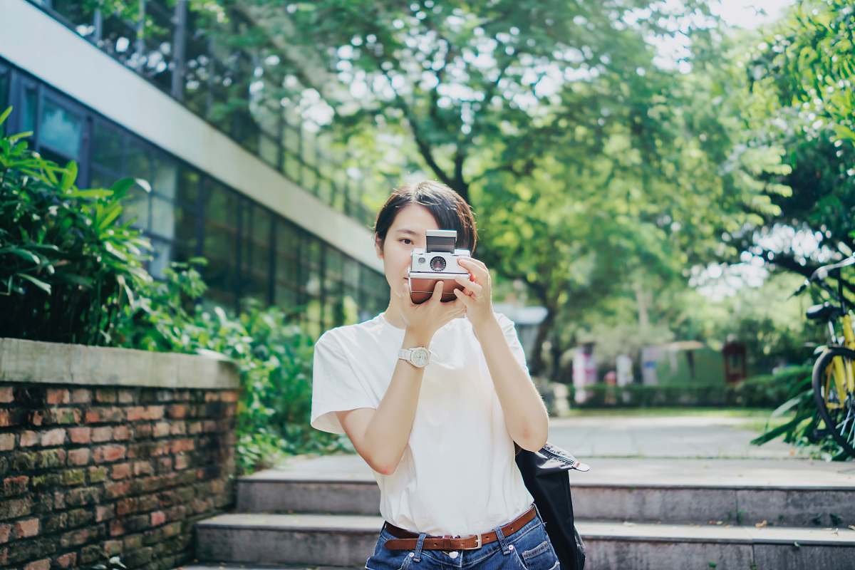 people woman in white T-shirt using camera human