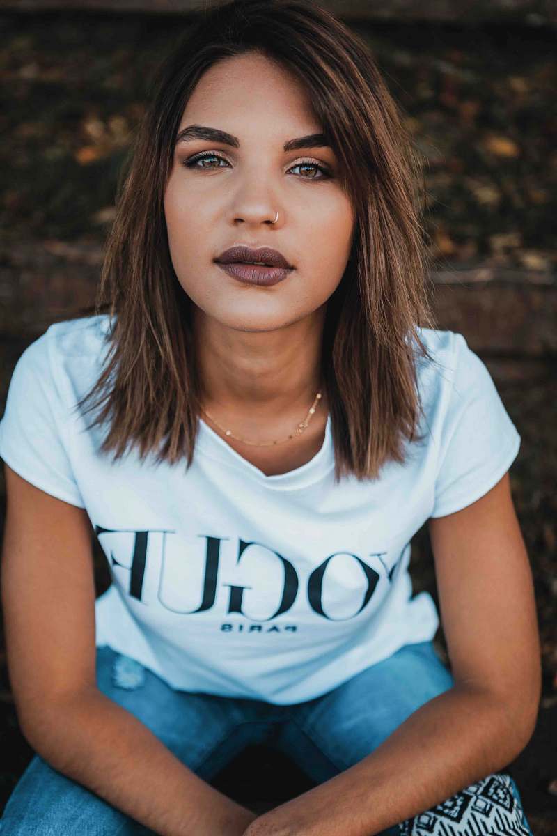 people woman in white Vogue t-shirt and blue jeans human