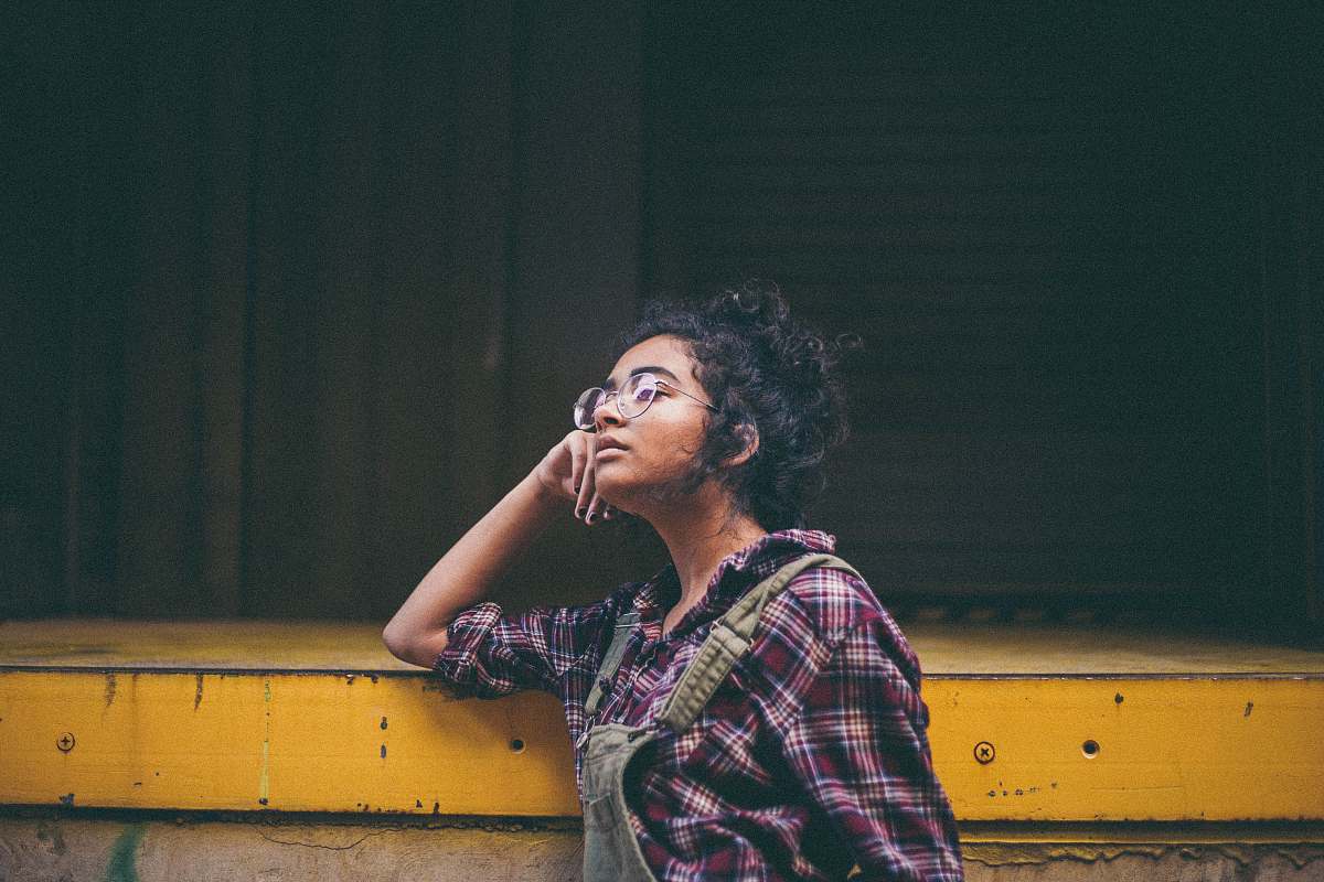people woman leaning on yellow surface human