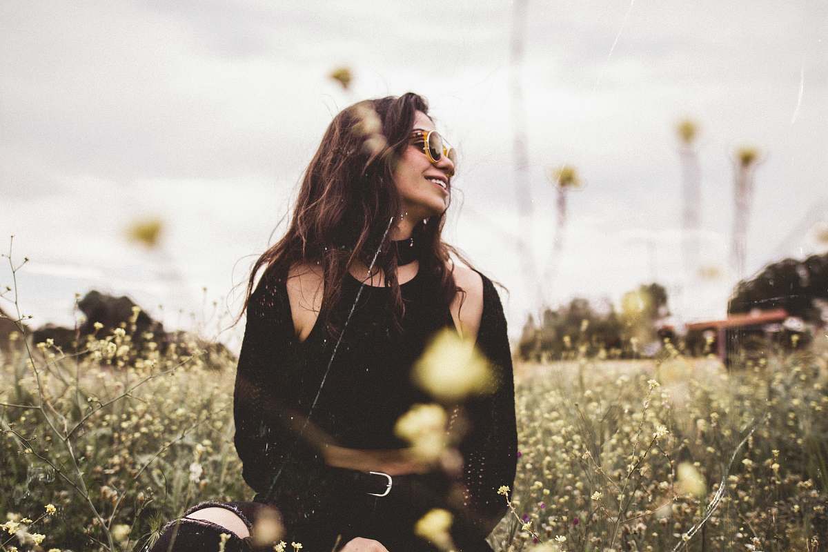 human woman looking left with flowers on background people