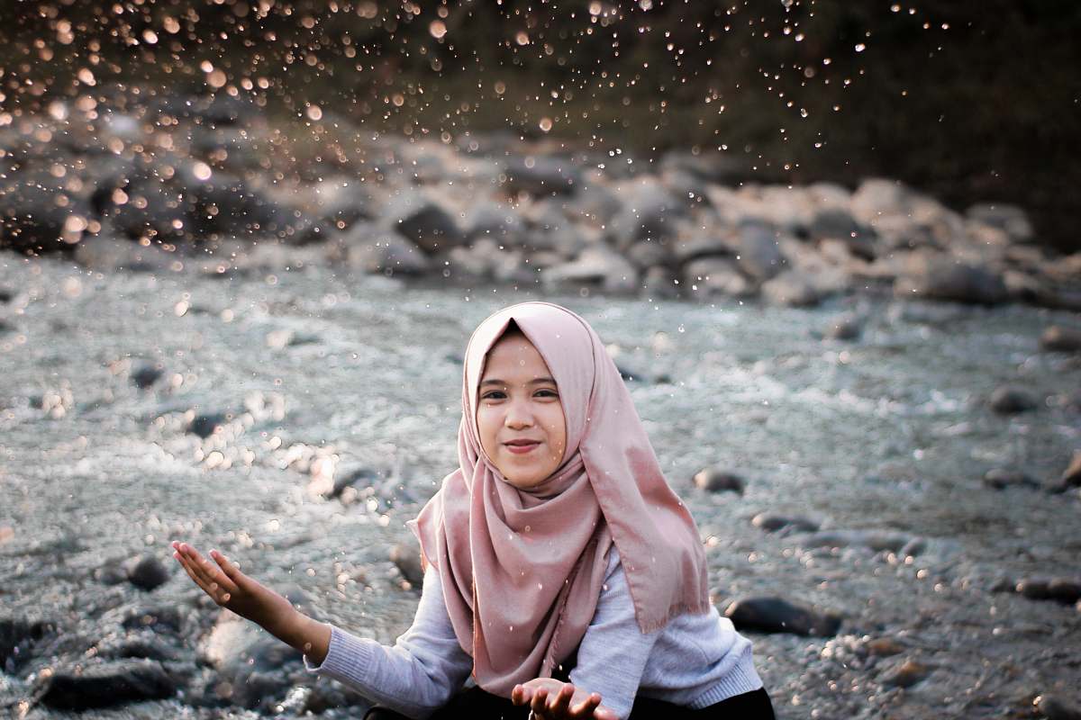 people woman playing with water on river human