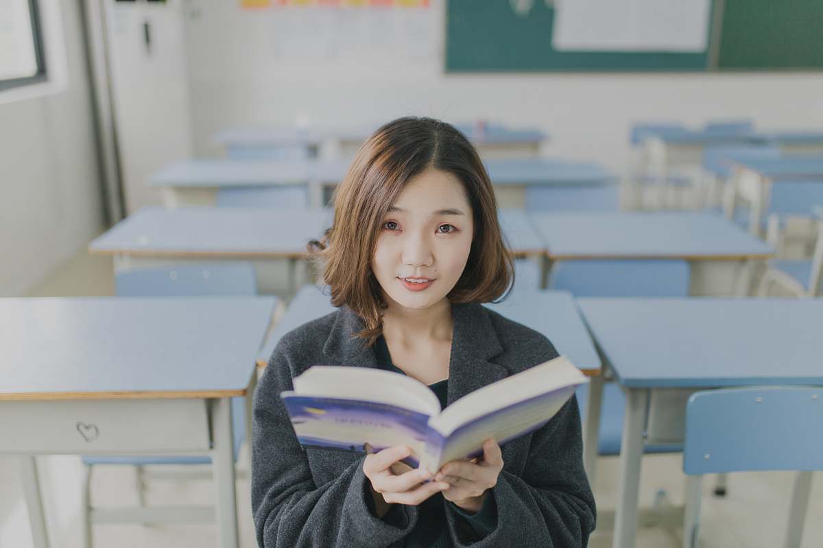 Human Woman Reading Book Sitting On Chair In Room People Image Free Photo