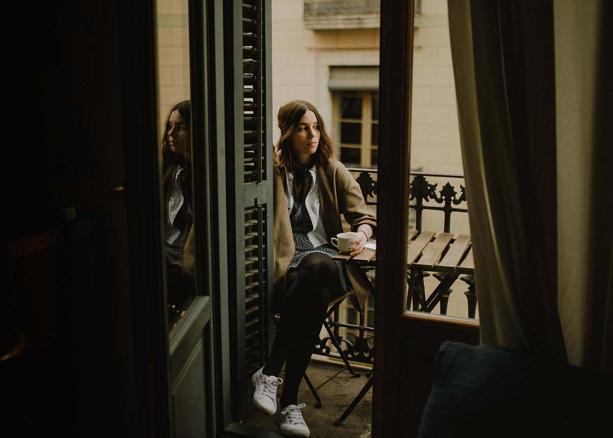 people woman sitting on chair holding cup human