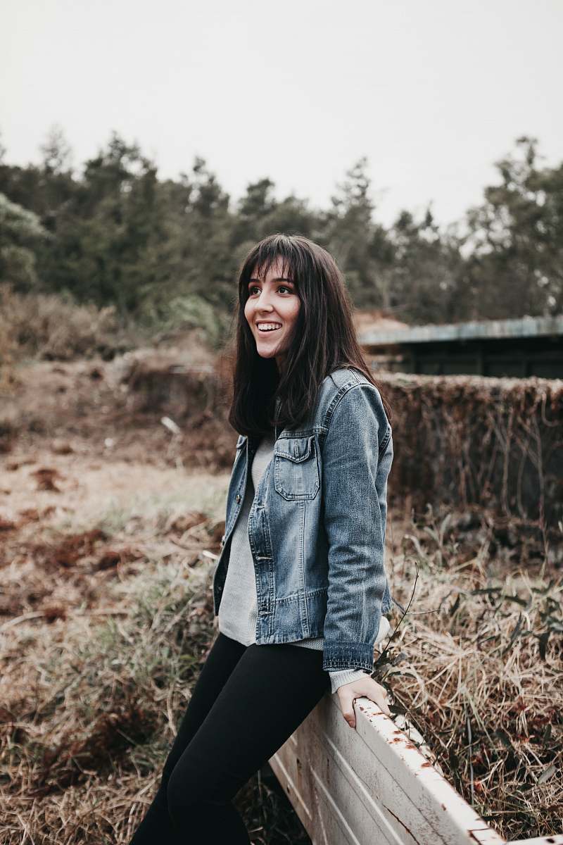 human woman sitting on rail during daytime people