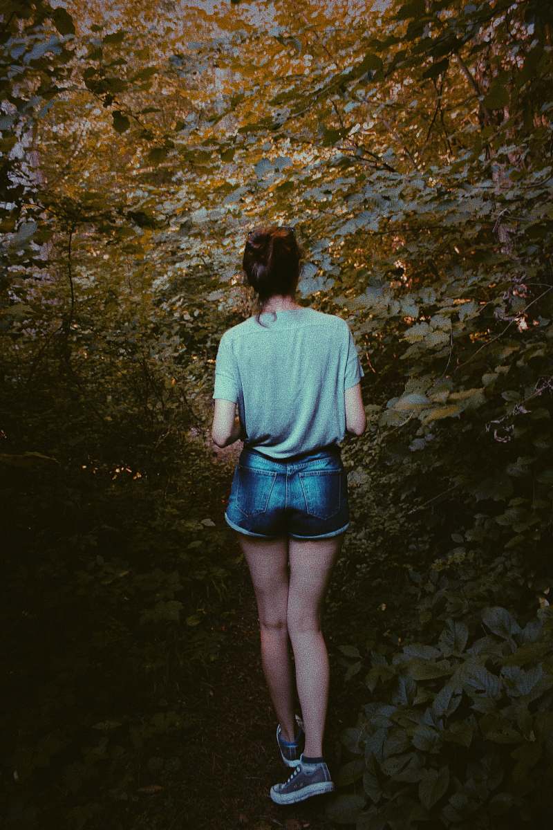 human woman standing between trees people
