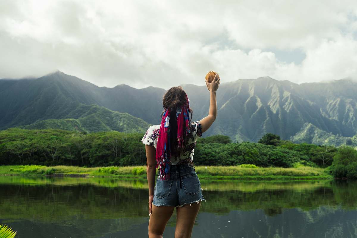 human woman standing facing green thick forest during daytime people