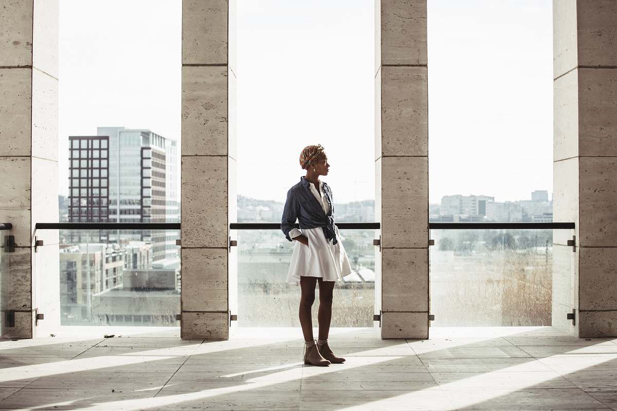 people woman standing in building next to window human