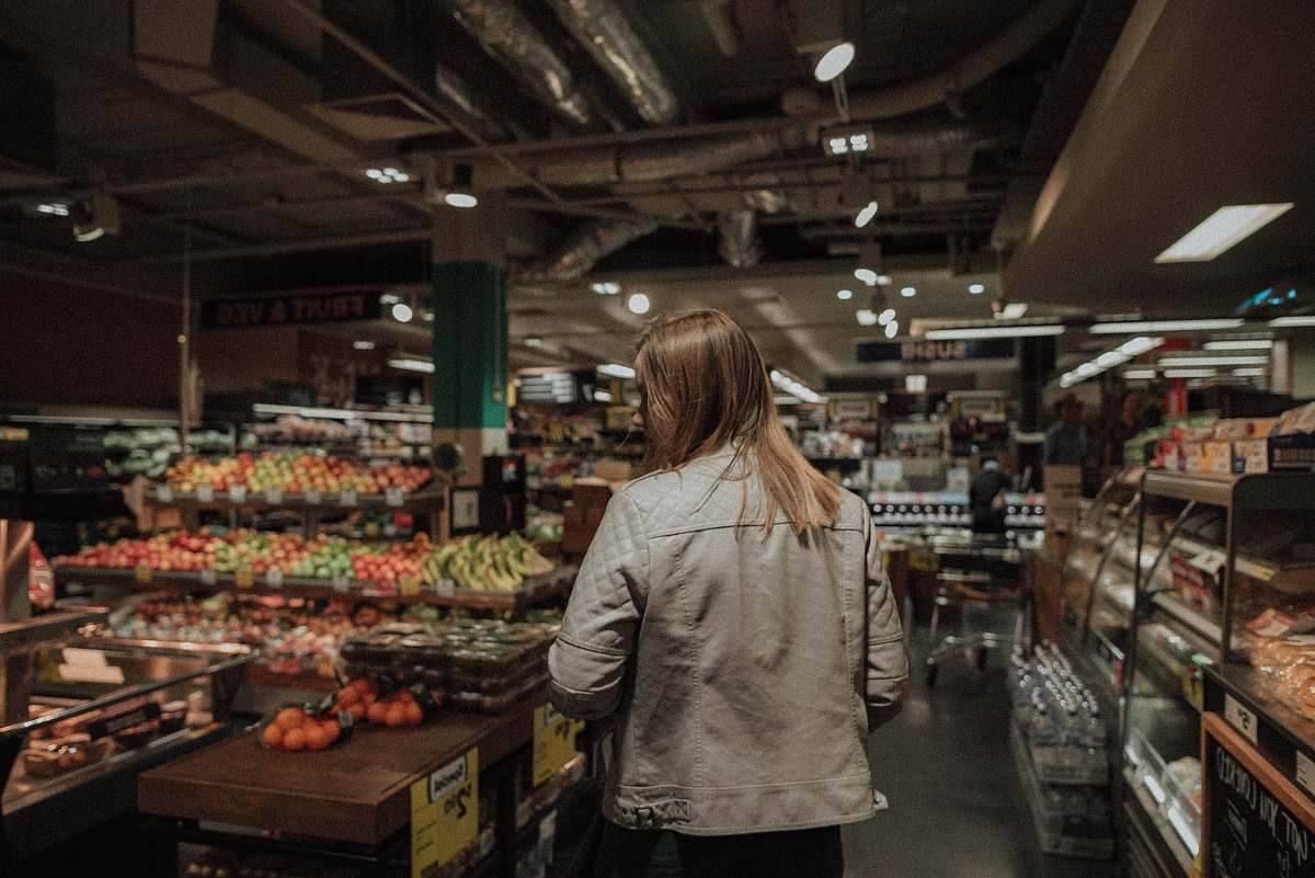 human woman standing in front of assorted vegetables people