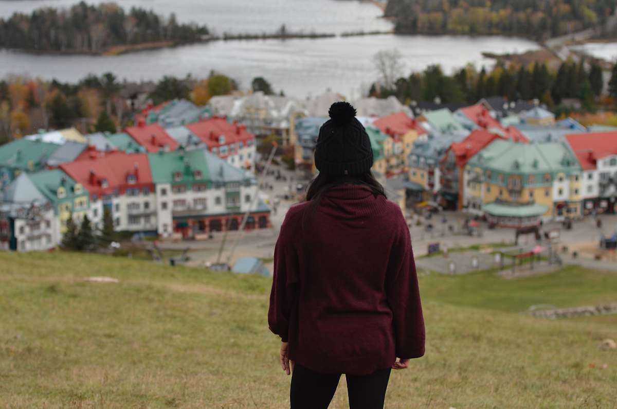 human woman standing in front of houses people