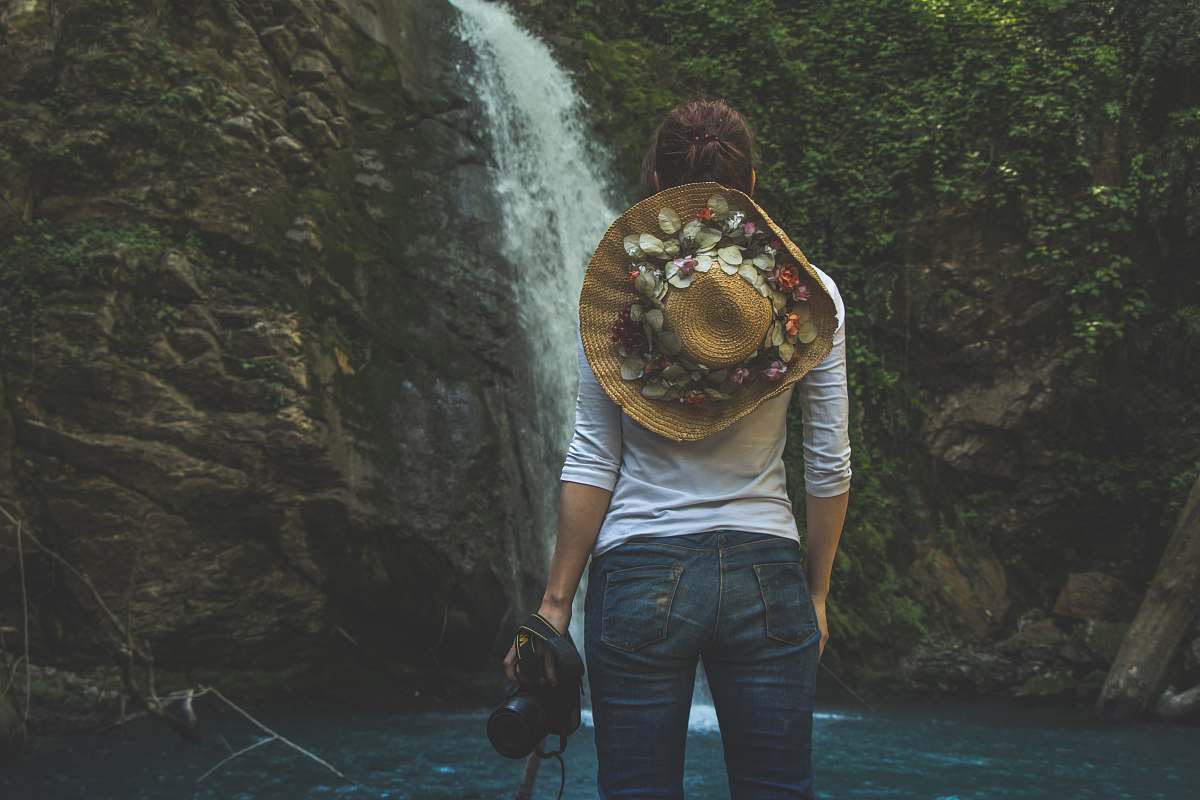 people woman standing in front of waterfalls human