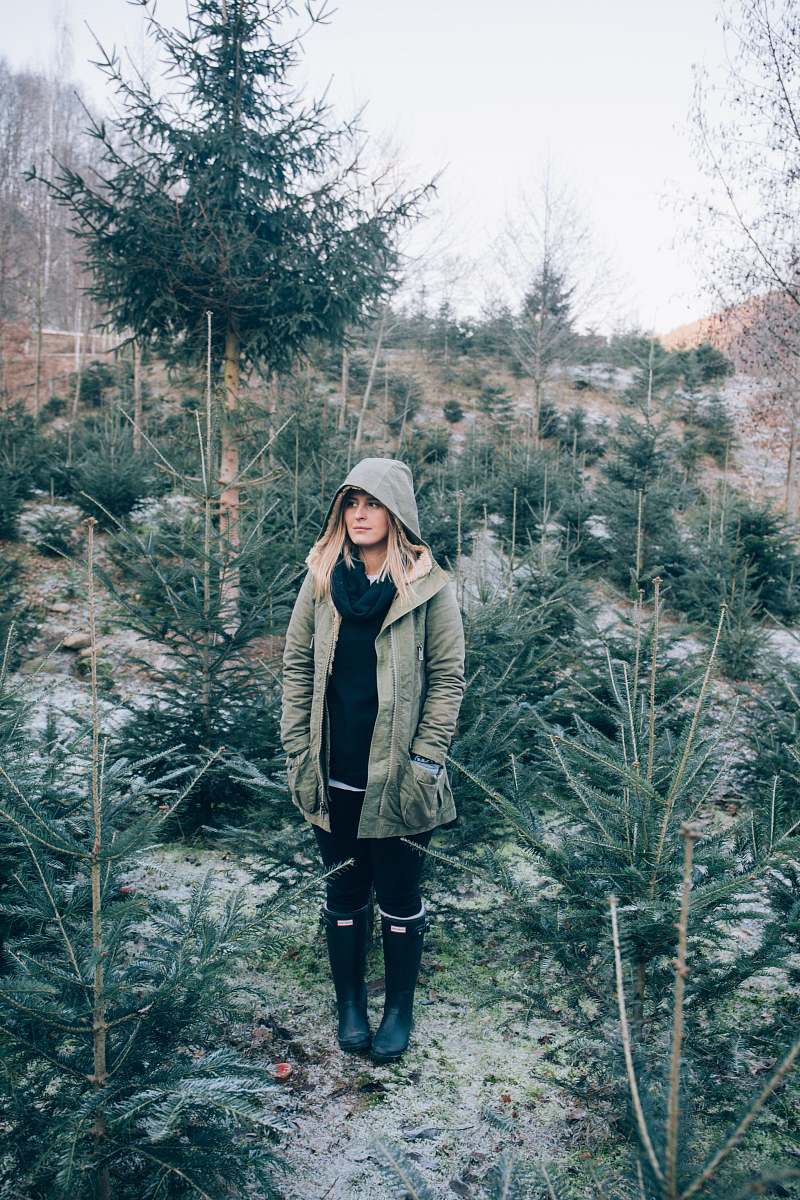 people woman standing near pine trees woman
