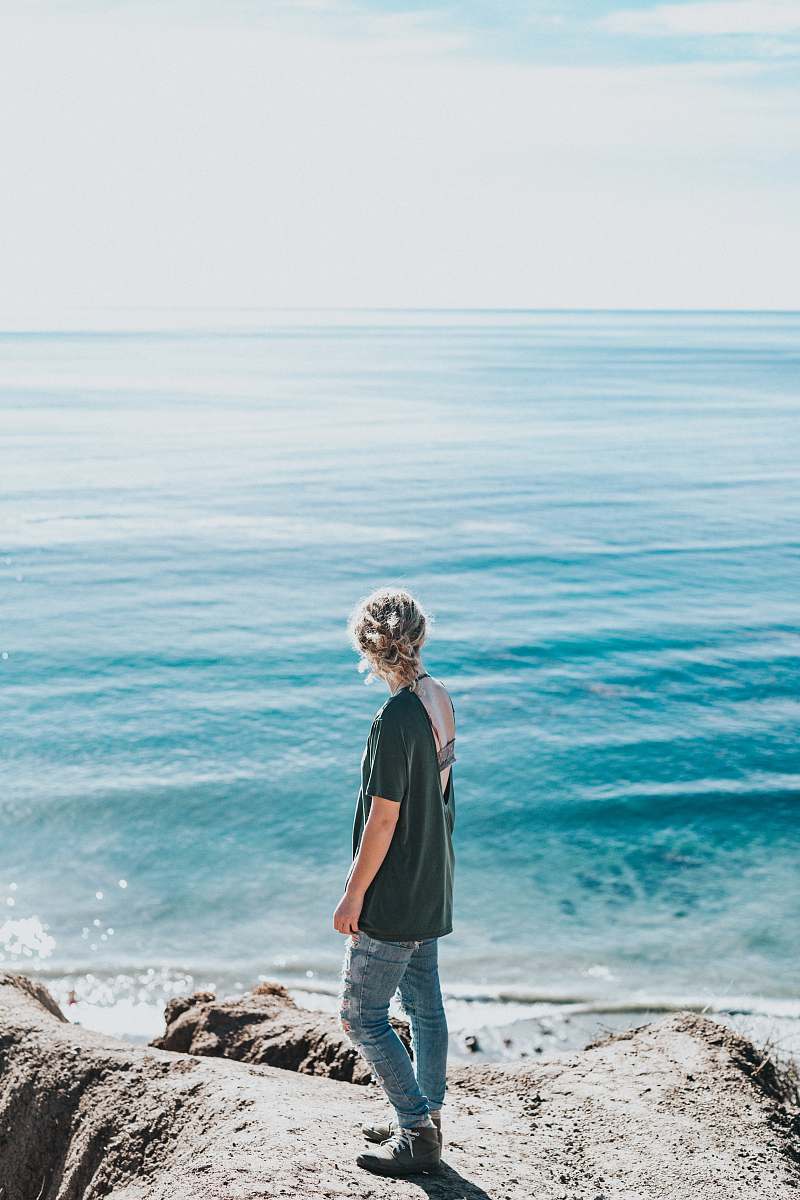 human woman standing next to sea people