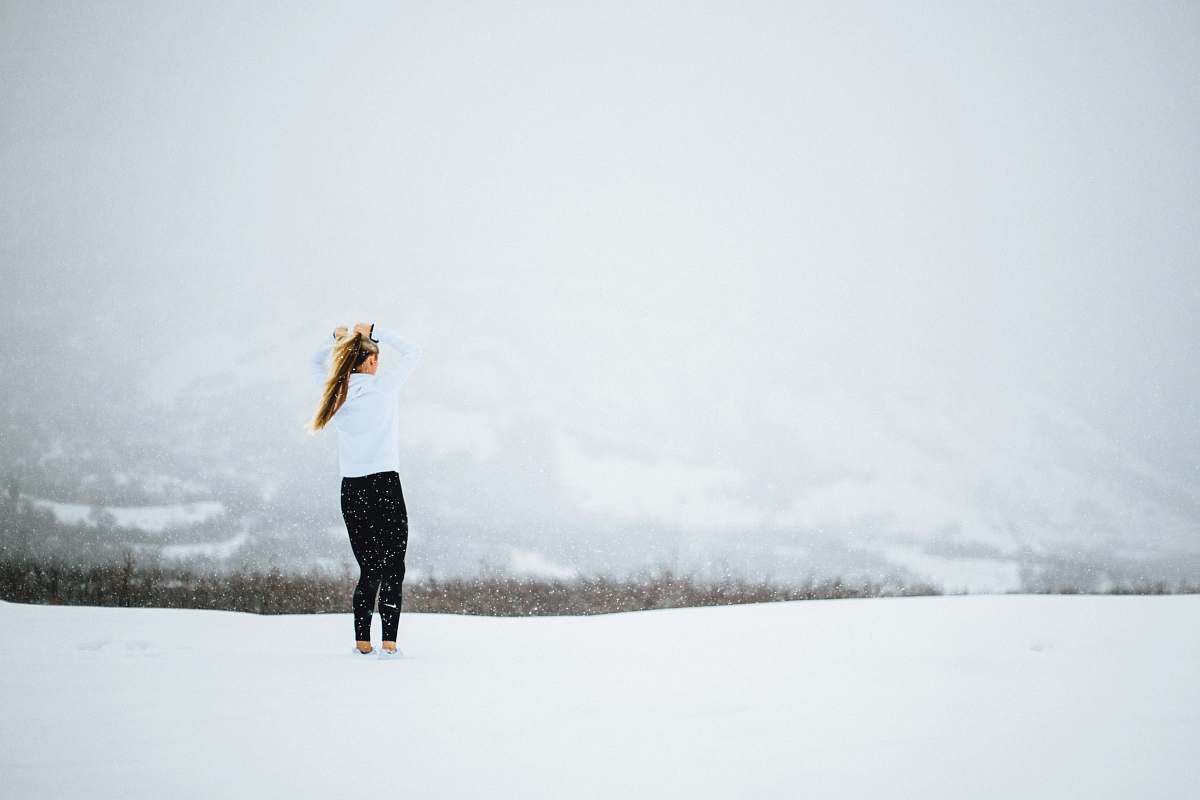 snow woman standing on open field covered in snow at daytime female