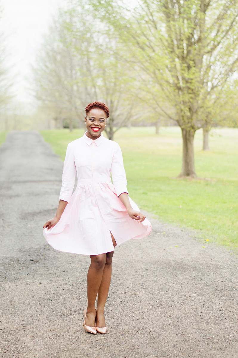 people woman standing on road while smiling during daytime human