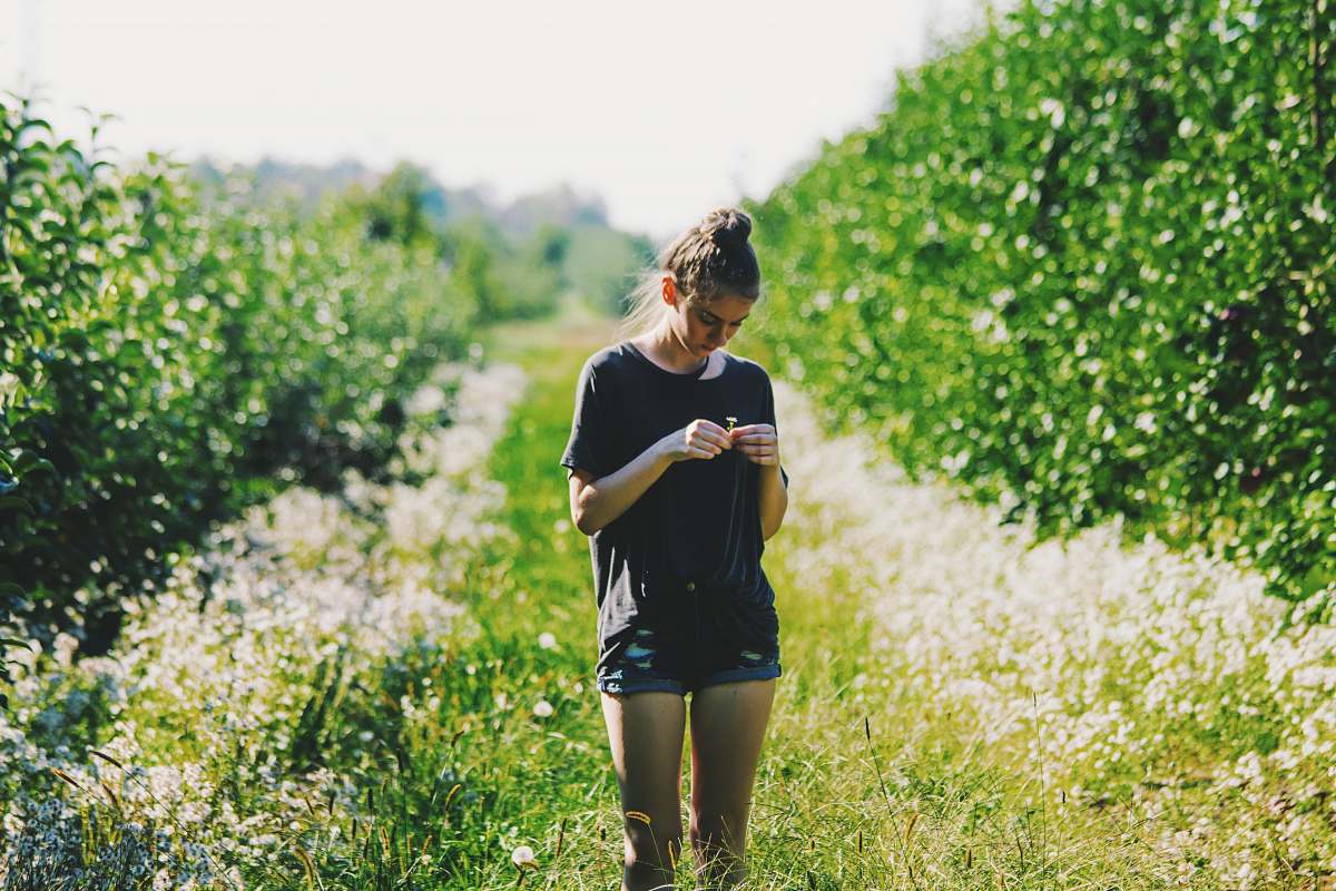 people woman surrounded by trees under sunny sky human
