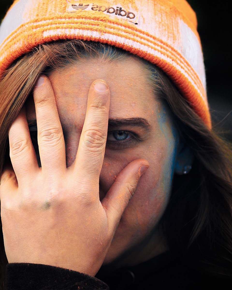 human woman wearing adidas cap holding her face people