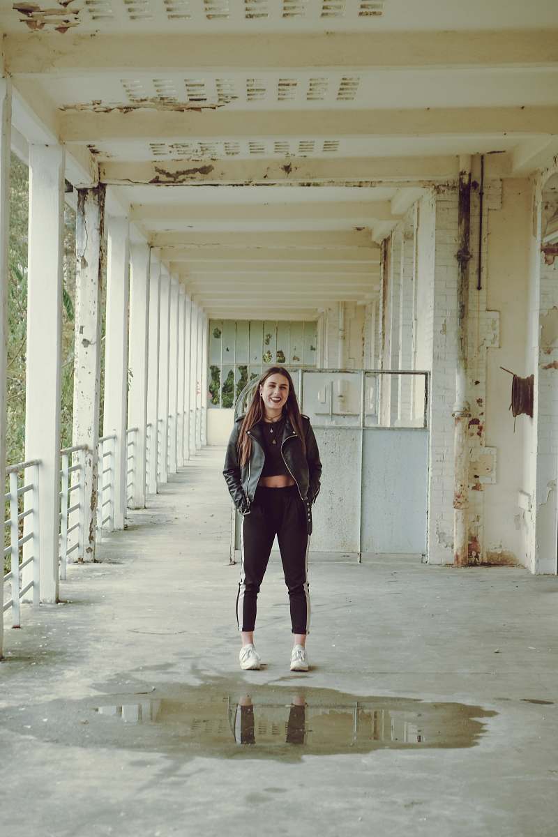 people woman wearing black and white track pants during daytime human
