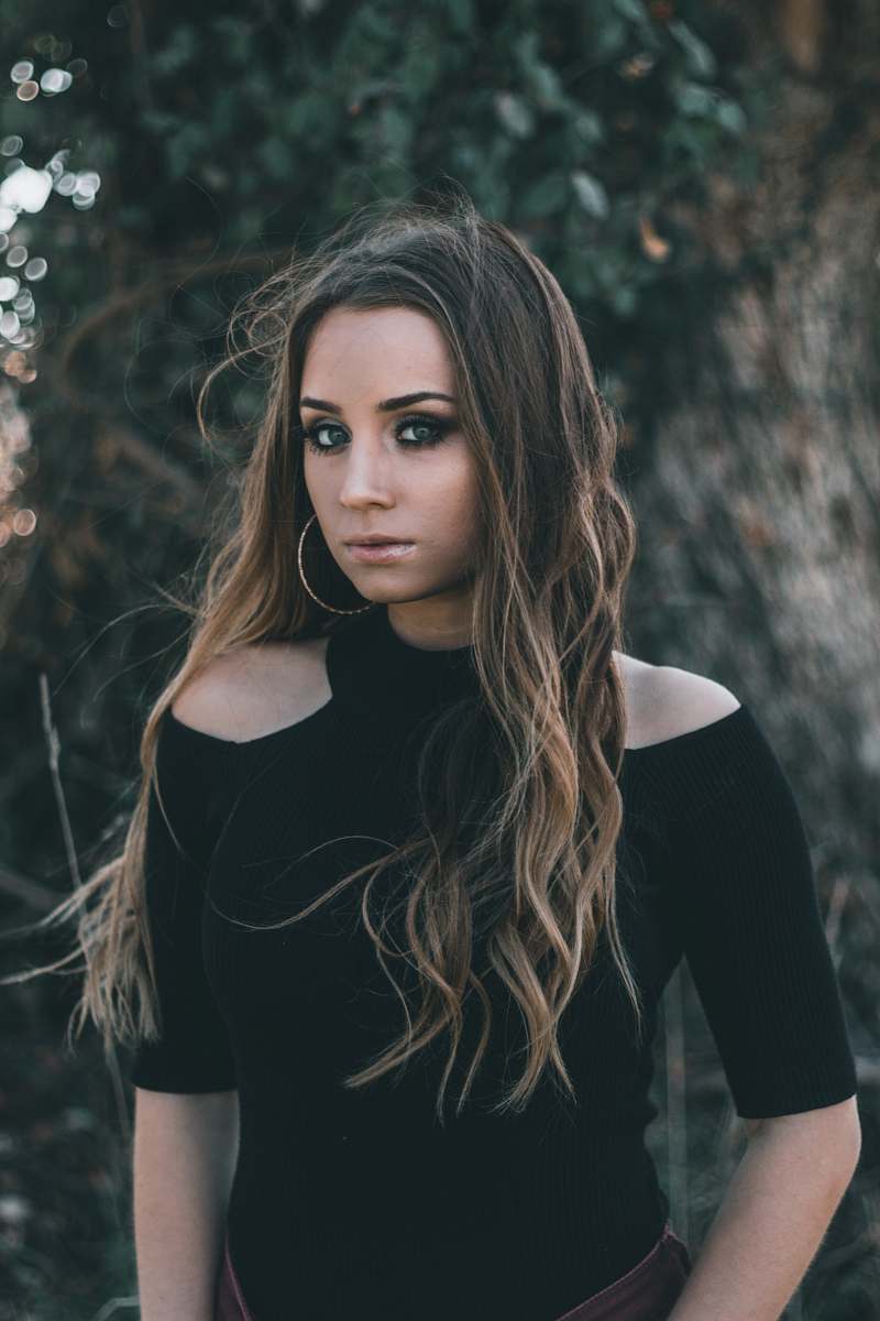 human woman wearing black cold-shoulder blouse people